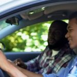 A teen is pictured driving here, her father sitting next to her in the front seat.