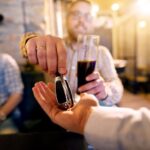 A young man makes the smart choice to hand over his key fob while he enjoys a good time with friends at the bar.