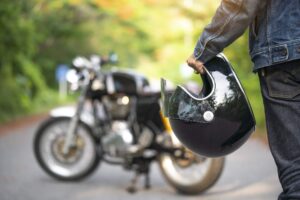 A motorcycle rider, helmet in hand, is pictured here getting ready to hit the road.